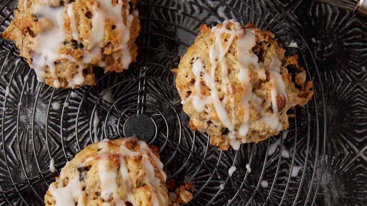 Three oatmeal scones next to a whisk.
