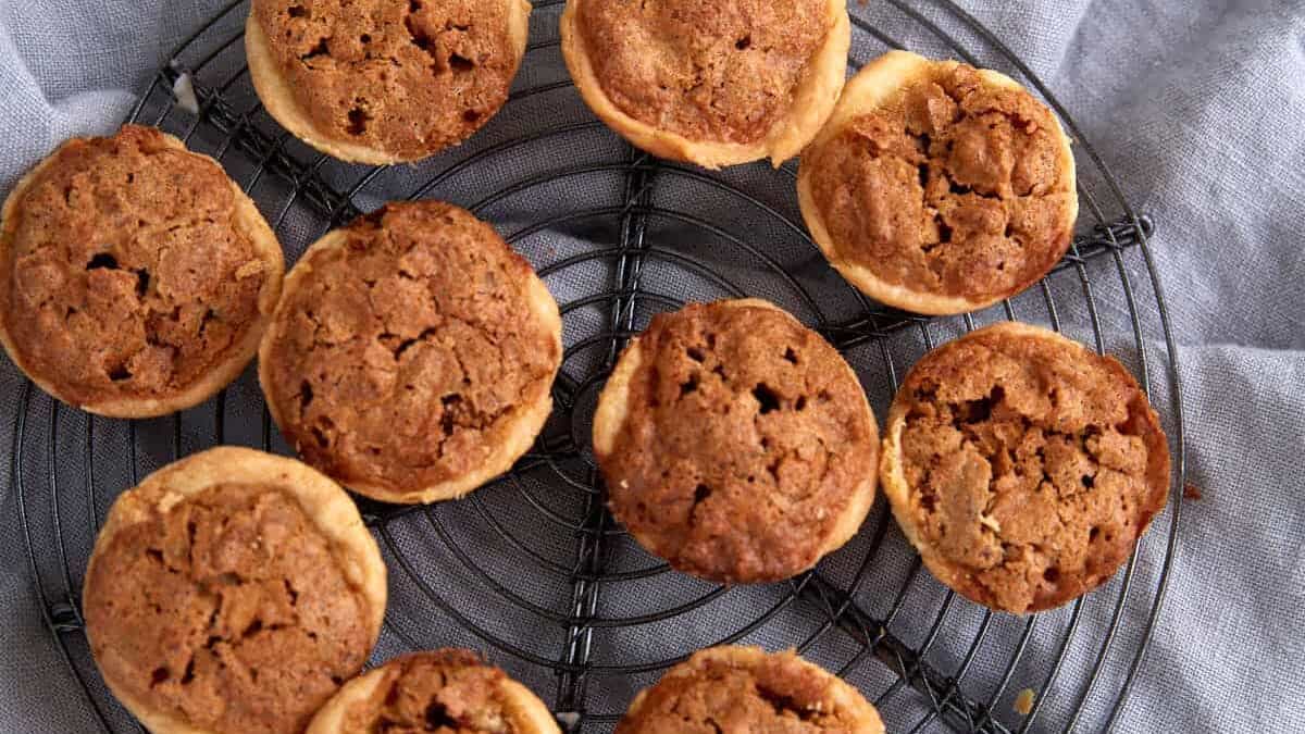 A circular rack topped with pecan tarts.