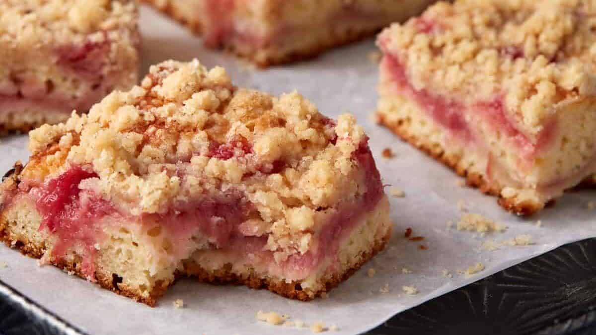 A piece of rhubarb coffee cake with a bite taken out.