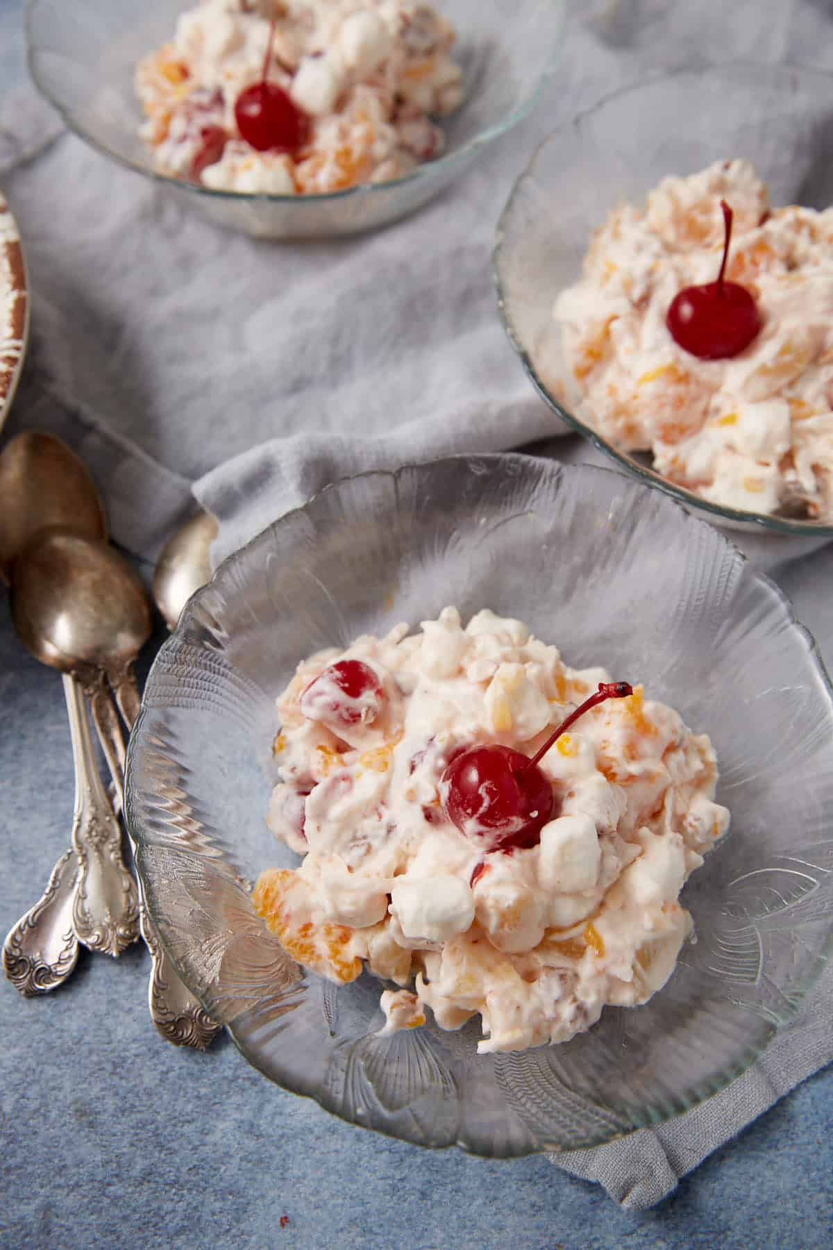 serving of ambrosia salad in a clear bowl.