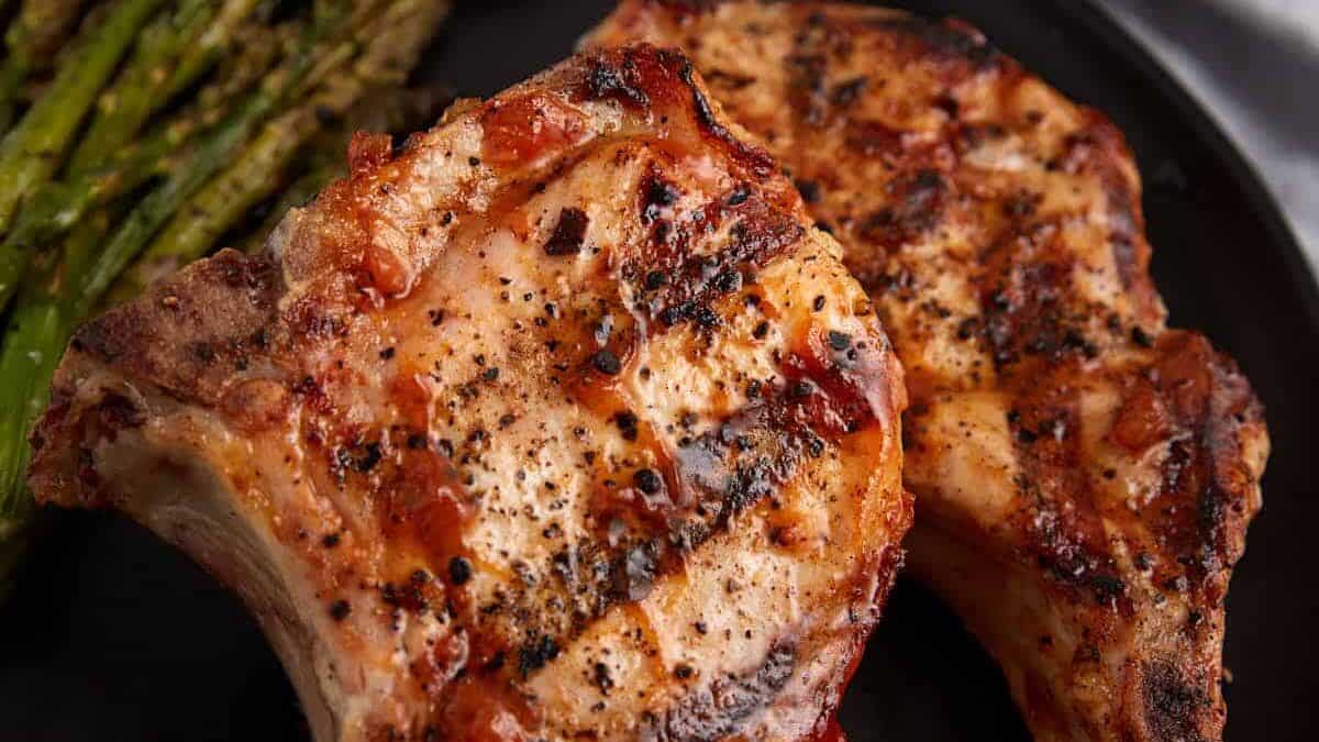 BBQ pork chops with peach sauce on a plate.