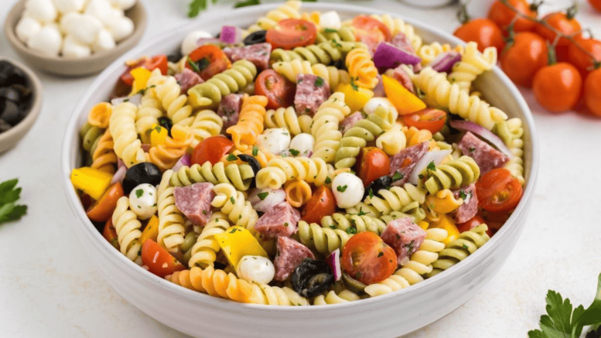 Pasta salad with ham, tomatoes, and olives