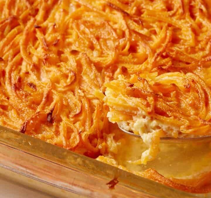 A spoon full of sweet potato pudding.