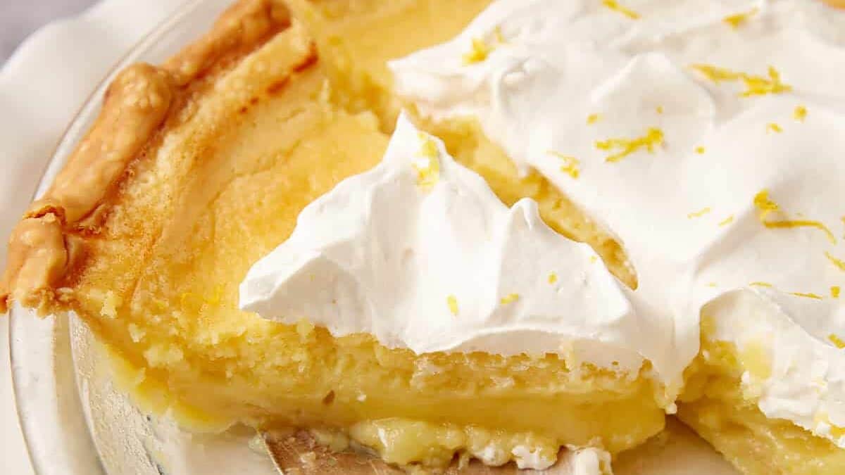 A slice of pie being removed form a pie plate.