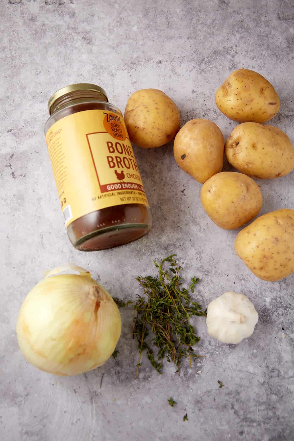 oven roasted potatoes ingredients on a gray background.