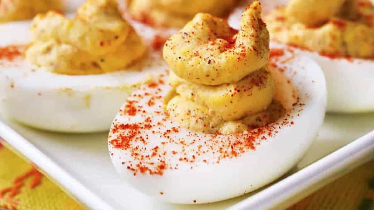 Deviled eggs on a white platter.