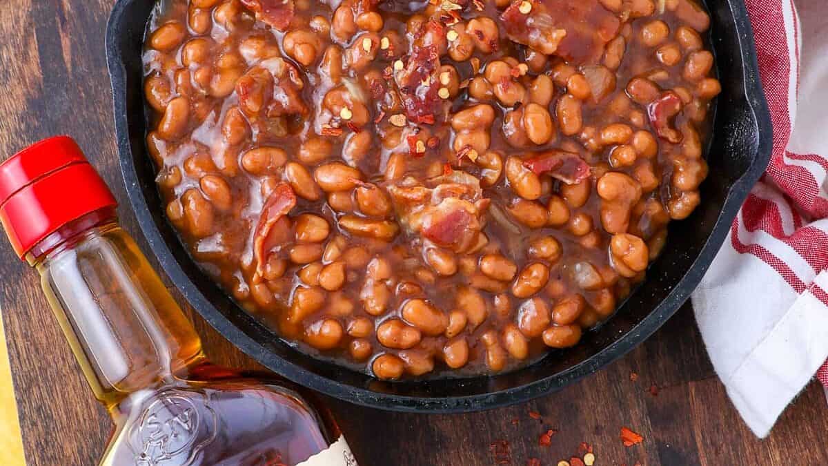 Bacon and beans in a skillet.