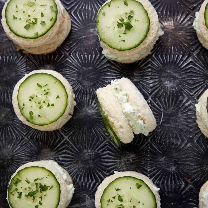 A tray of cucumber sandwiches lined in rows.
