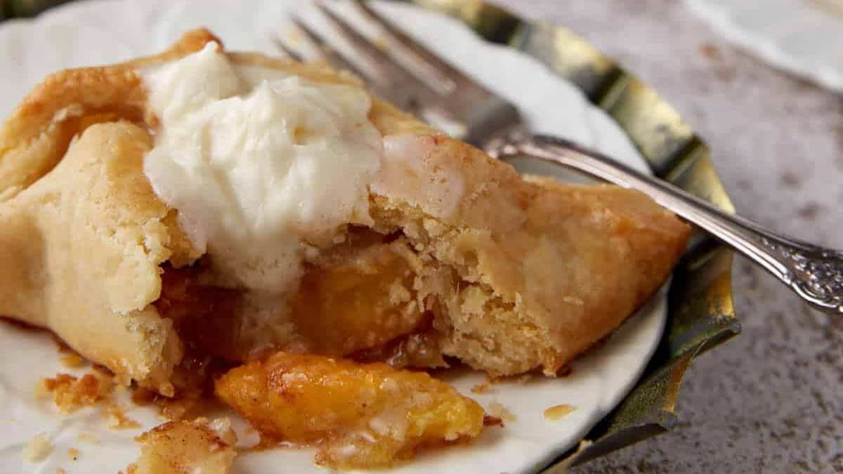 A bite taken out of a peach dumpling.