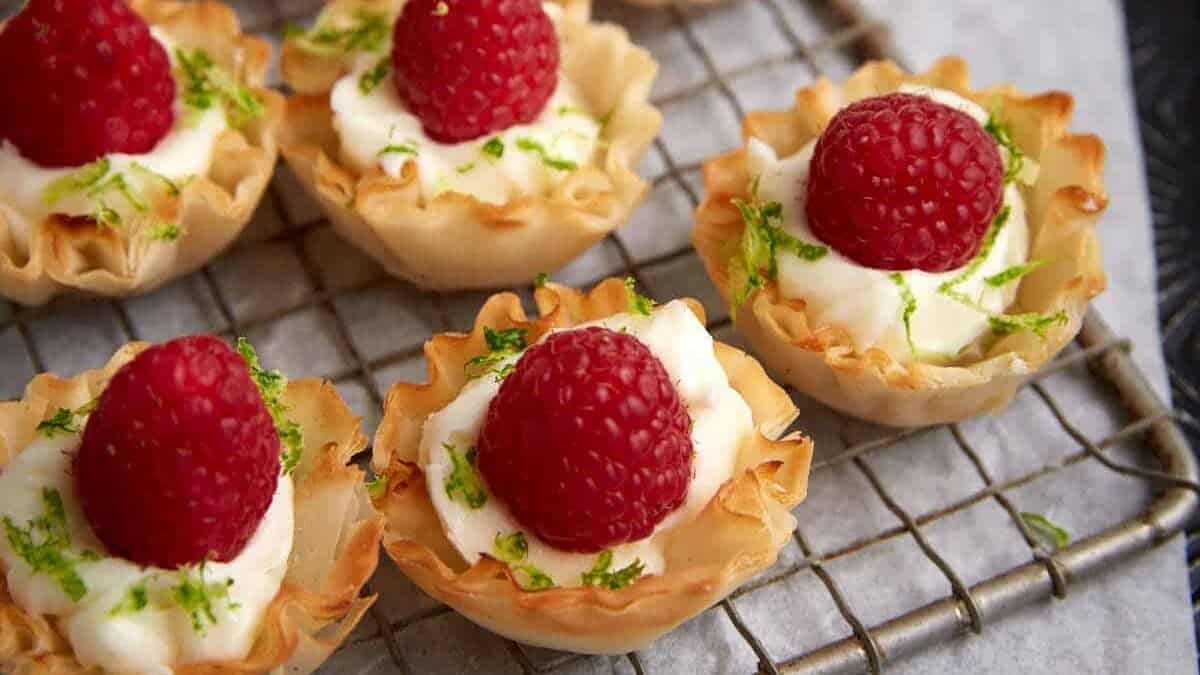 Buttery tart shells filled with sweet raspberry jam and glaze.