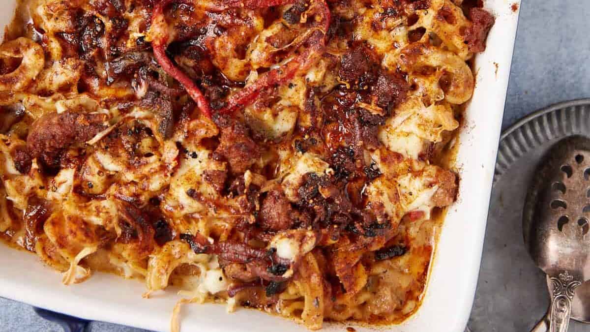 A casserole dish with sausage mac and cheese.