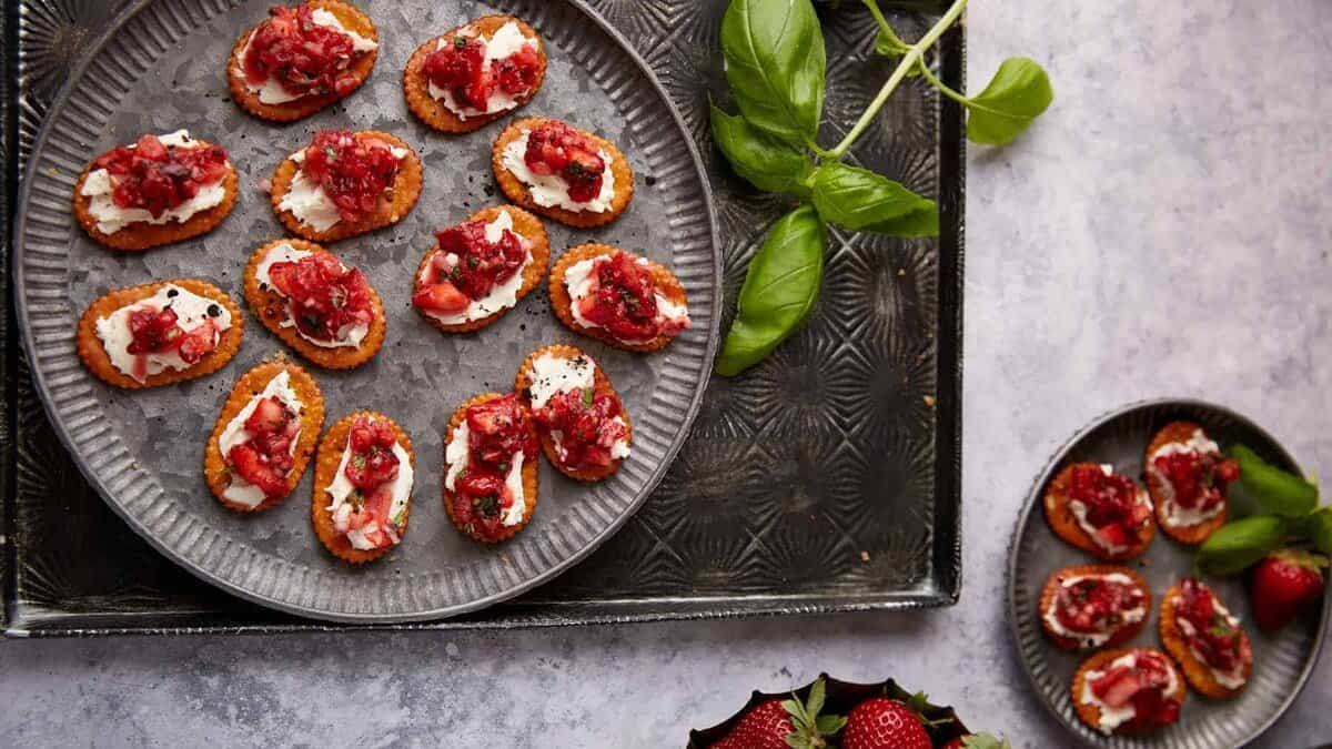A platter and appetizer plate of strawberry pretzel crackers.