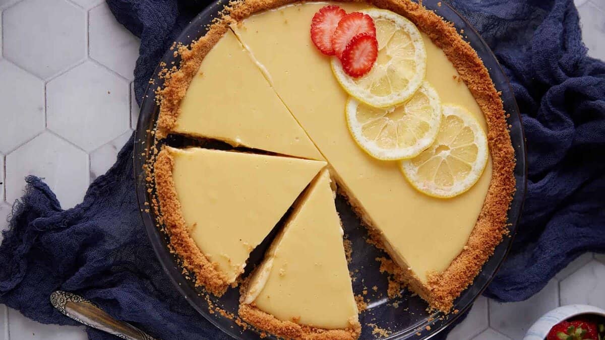 A Lemonade pie topped with strawberries.