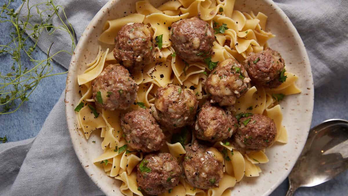 A serving platter with baked meatballs.