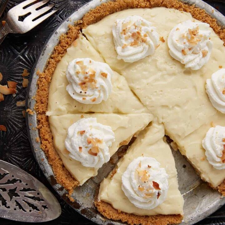 A coconut custard pie with a slice removed.