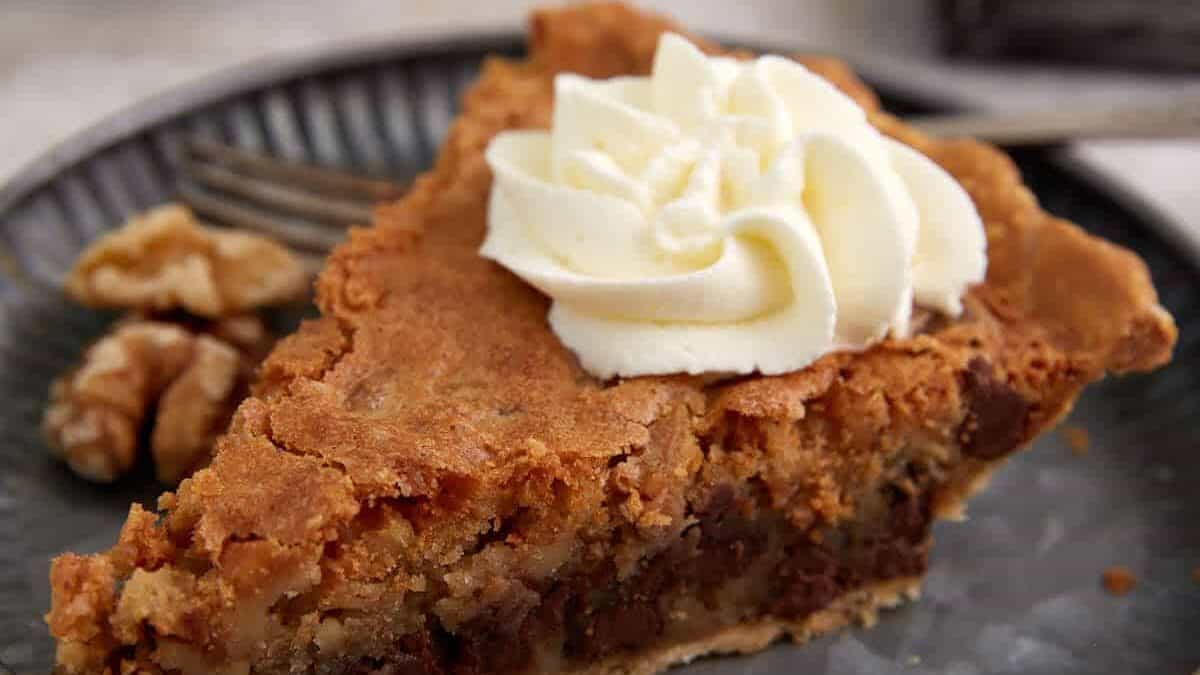 A slice of derby pie on a plate.