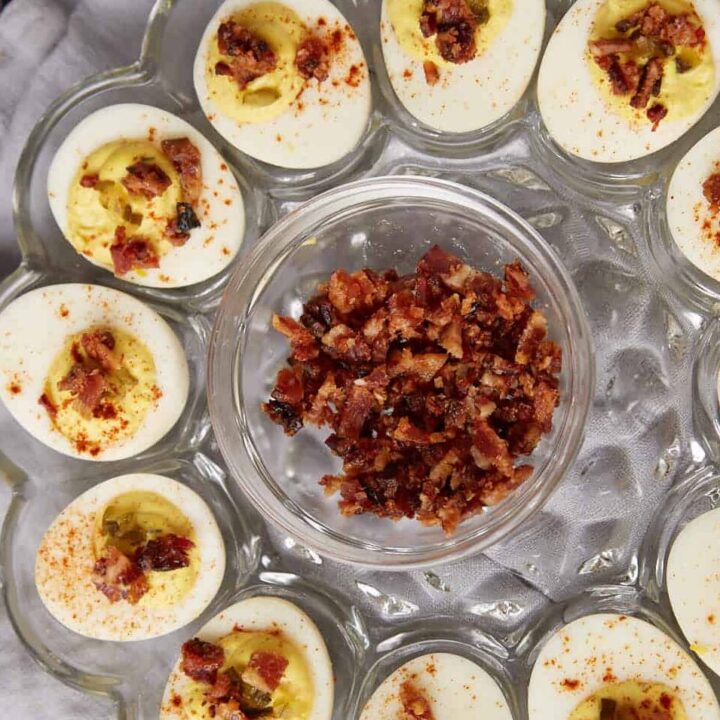 A glass platter filled with deviled eggs.