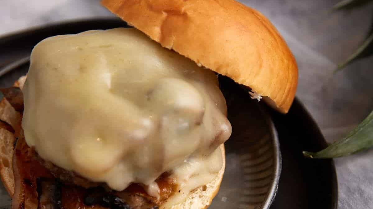 A pineapple burger on a plate with a bun.