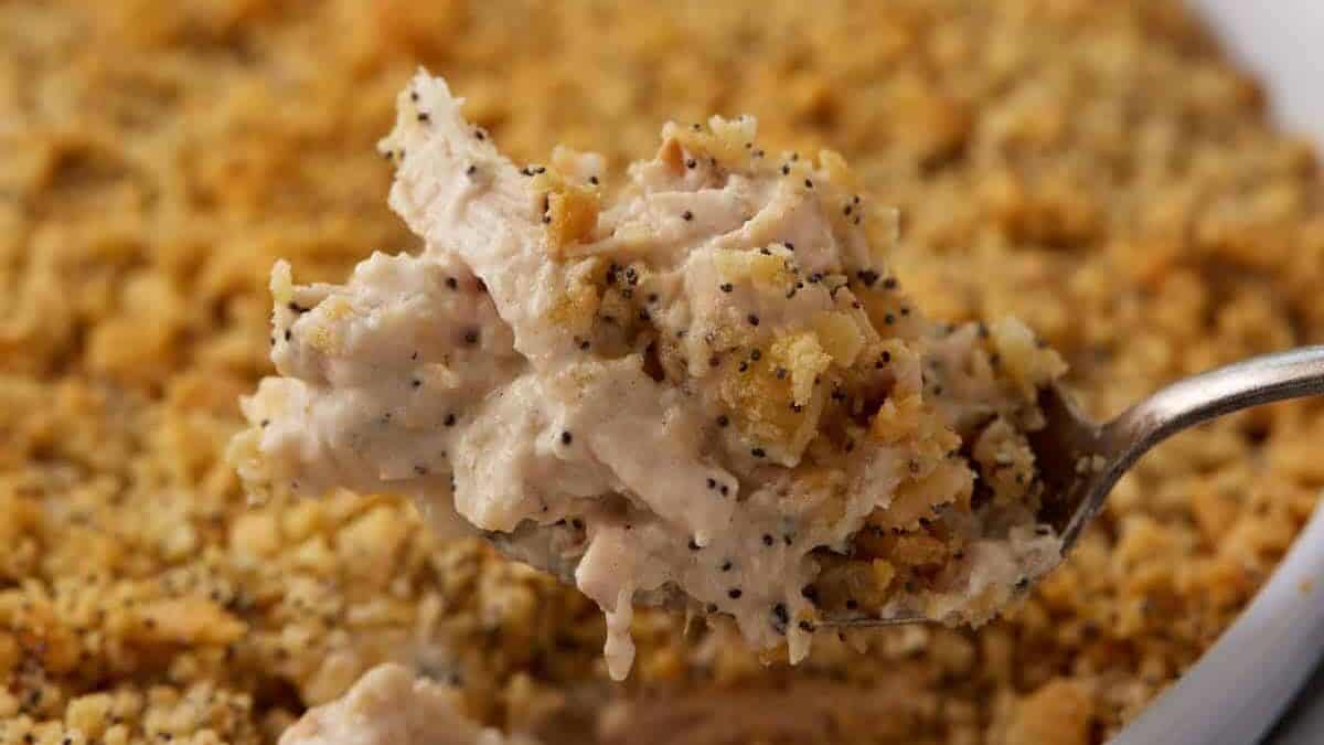 A serving spoon scooping out chicken casserole.