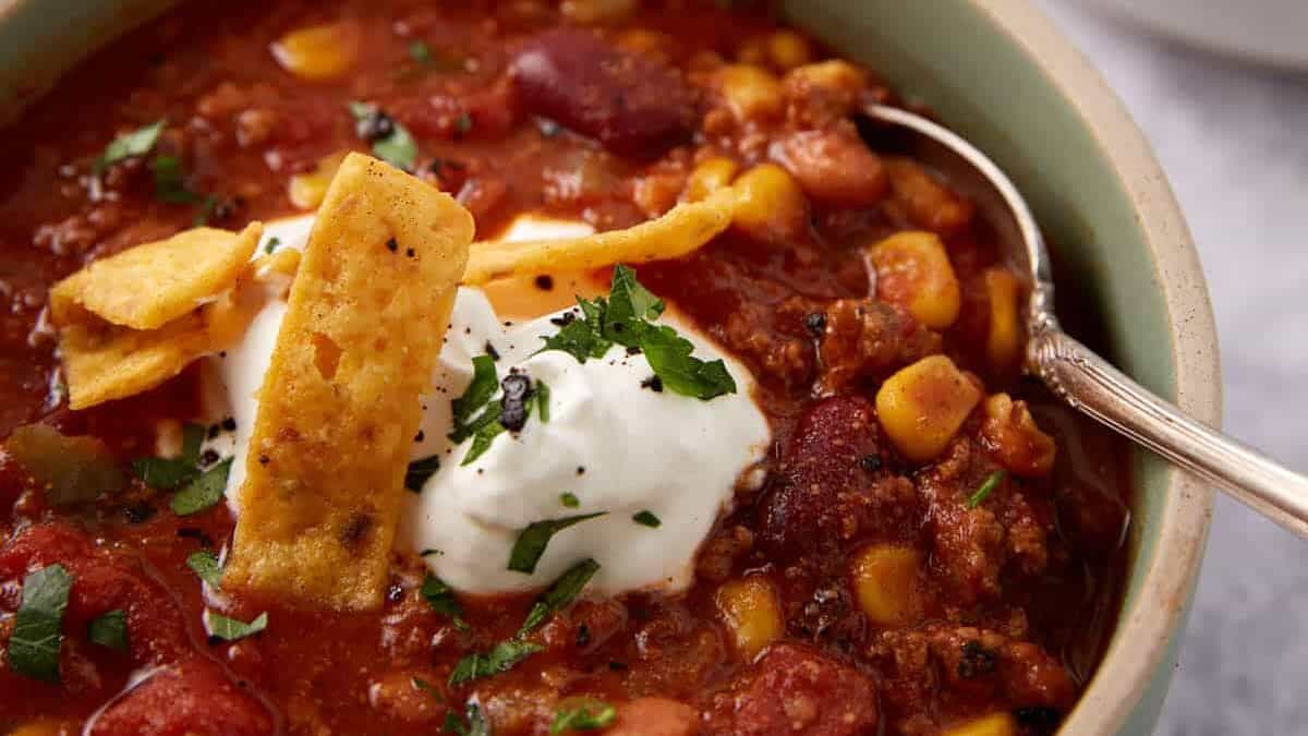 Taco soup topped with sour cream and corn chips.