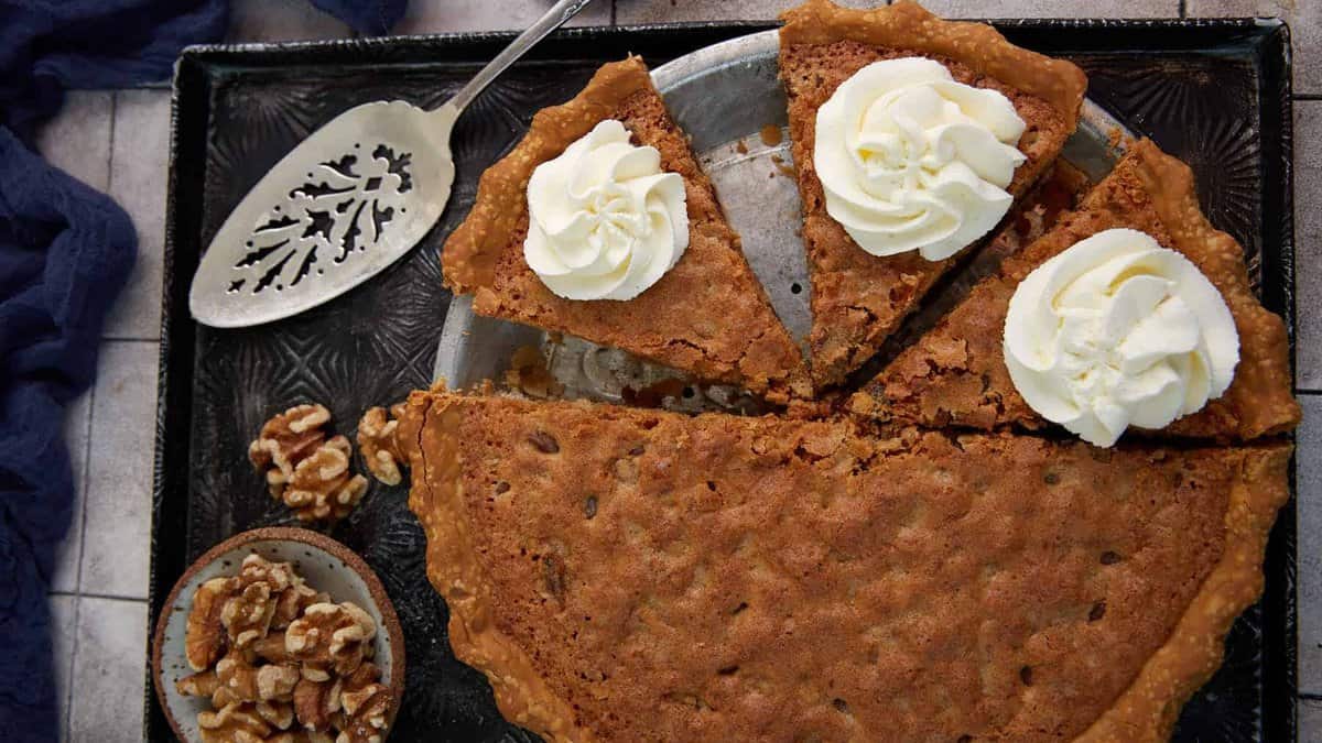 A derby pie with whipped cream on top.
