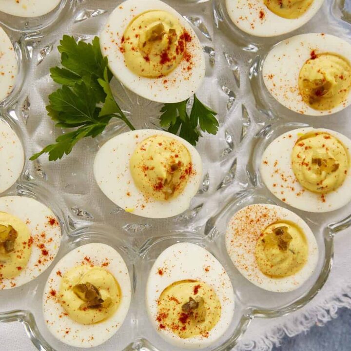 Deviled eggs with relish on an egg platter.
