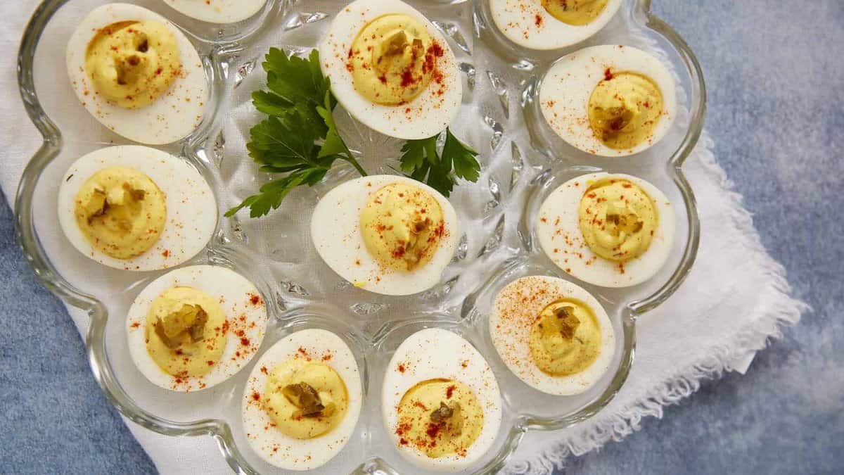 Deviled eggs with relish on an egg platter.