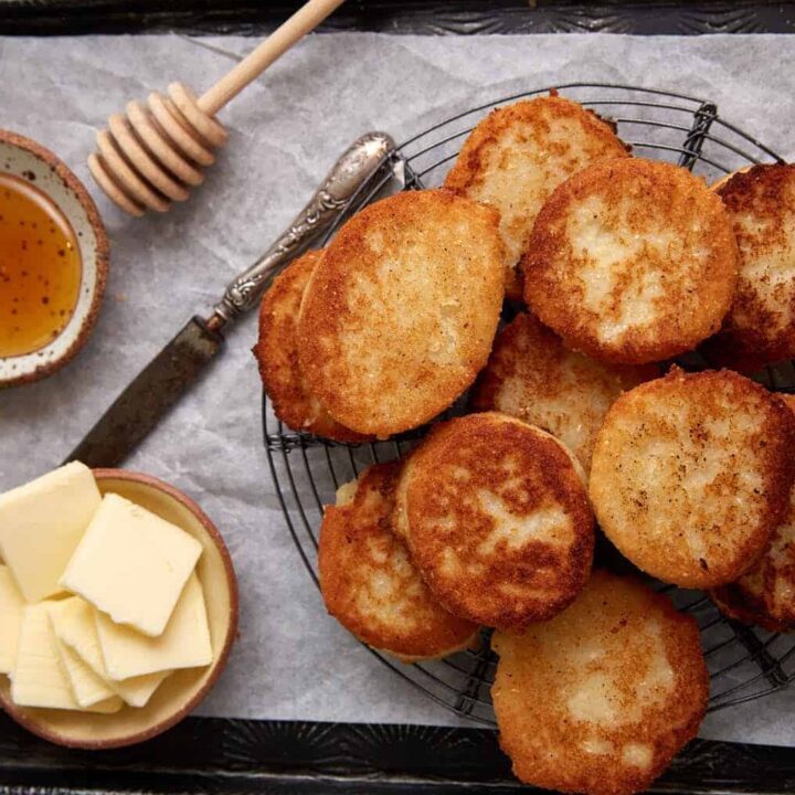A tray with hot water cornbread, butter and honey.
