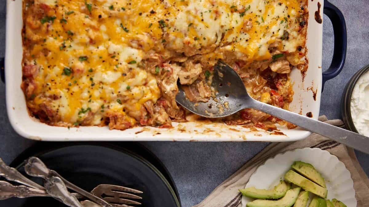 A baked king ranch casserole with a serving spoon.