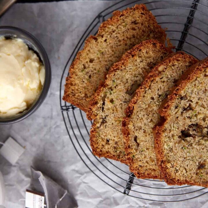 Slices of zucchini bread on parchment.