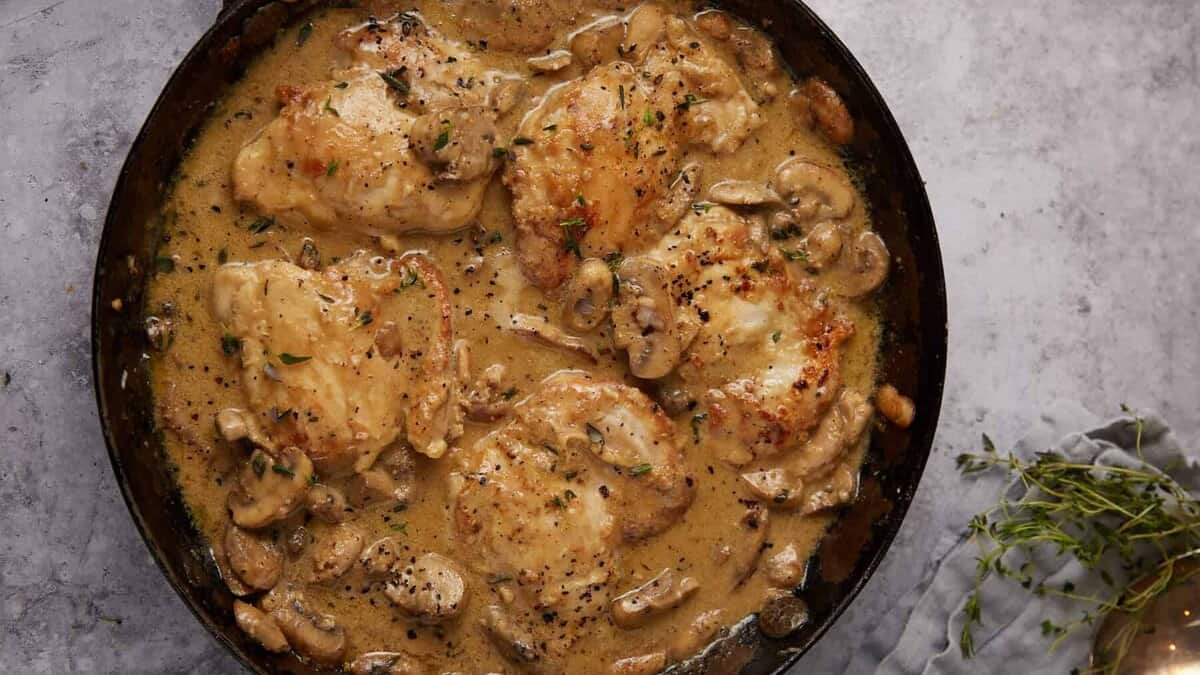chicken and mushrooms in a skillet.