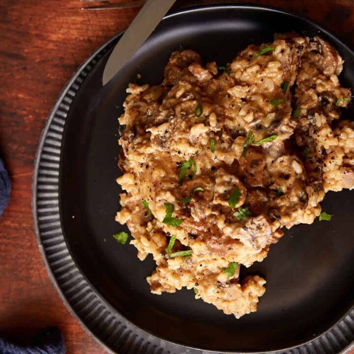 Mushroom soup and rice with a slow cooker pork chop on a plate.