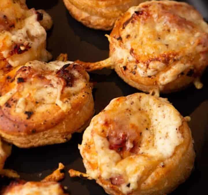 Mini Croque Monsieurs on a black platter.