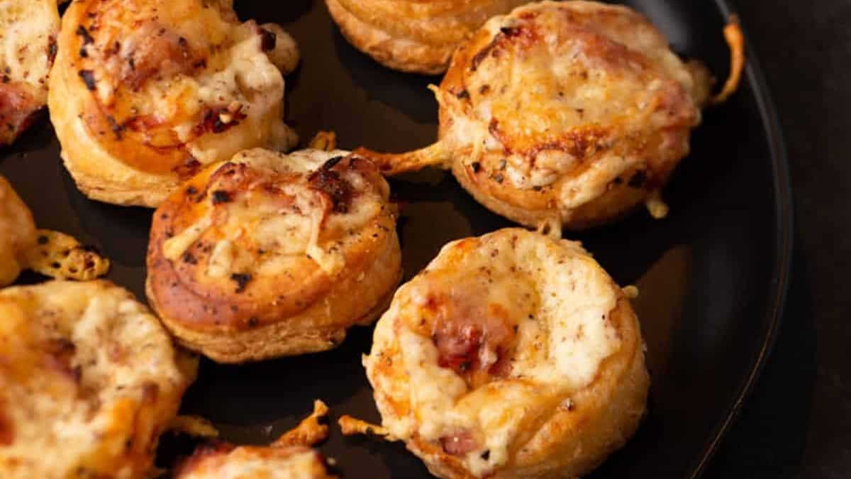 Mini Croque Monsieurs on a black platter.