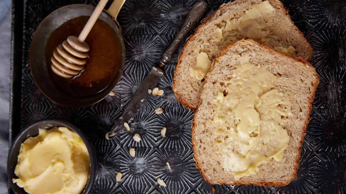 Slices of honey oatmeal bread on a tray.