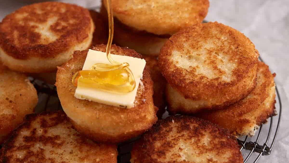 A rack of hot water cornbread with butter and honey.