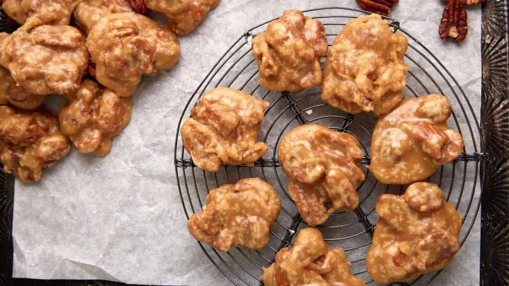 Pecan pralines on a cooling rack.