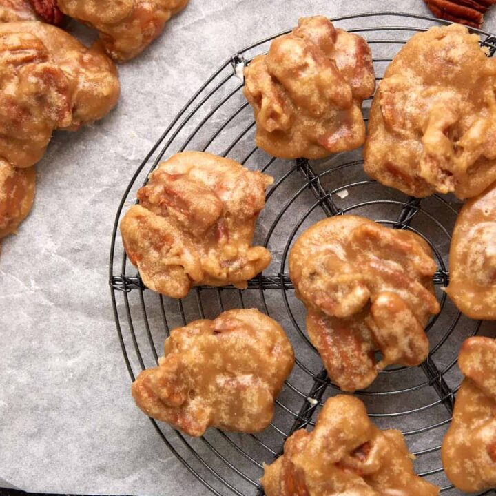 Pecan pralines on a cooling rack.