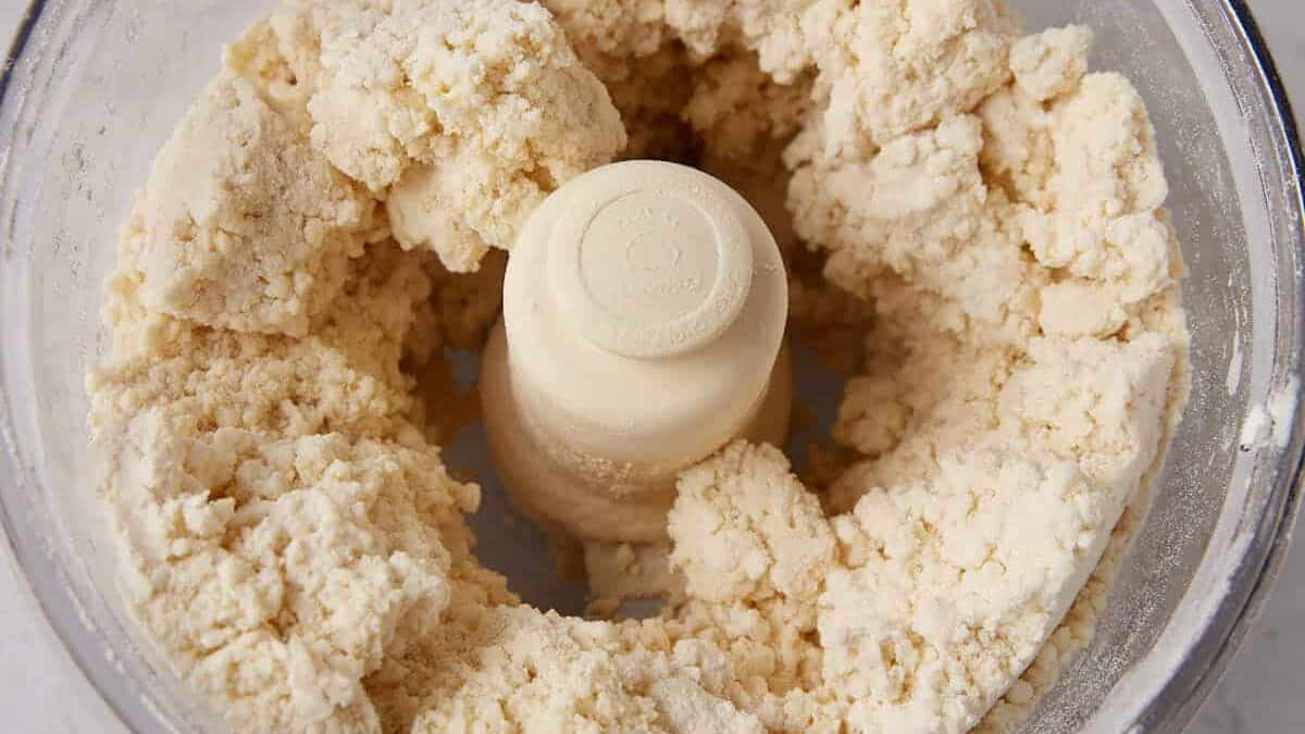 Buttermilk added to the biscuit dough in a food processor.