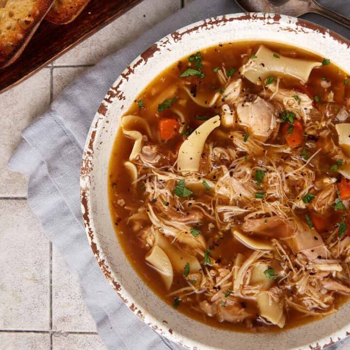 A bowl of crock pot chicken noodle soup.