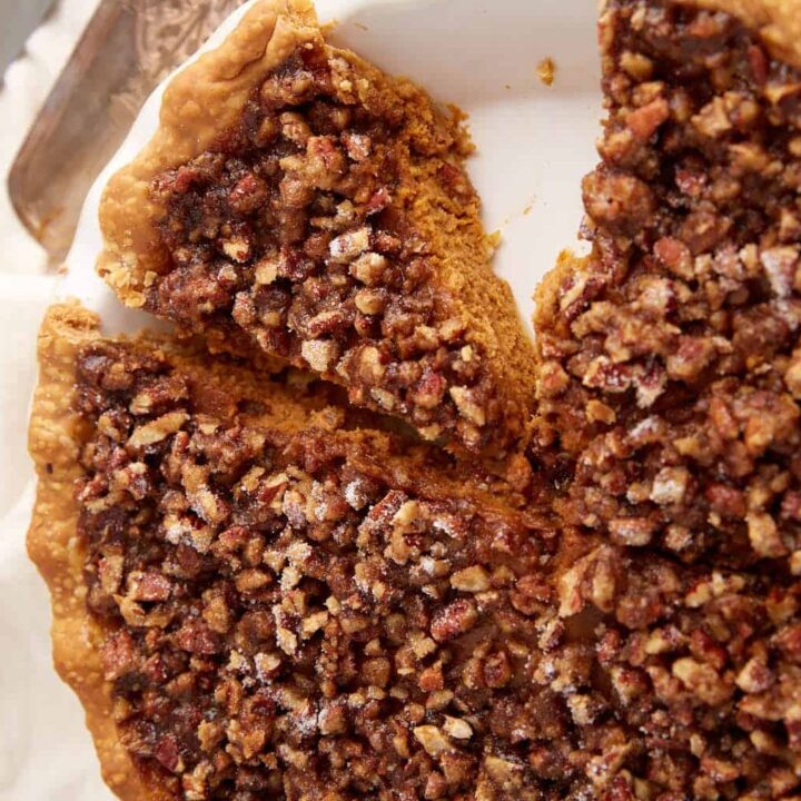 A pumpkin pie with a slice removed.