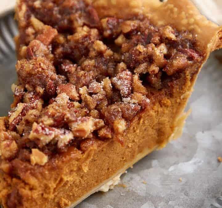 A slice of pumpkin pie topped with pralines.