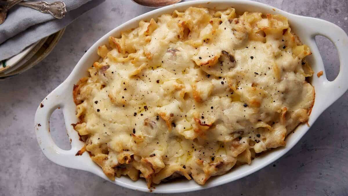 A casserole dish of baked kielbasa mac and cheese.