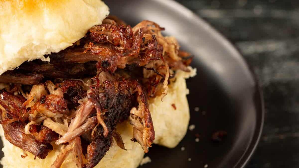 Crock pot carnitas served on a diner roll.