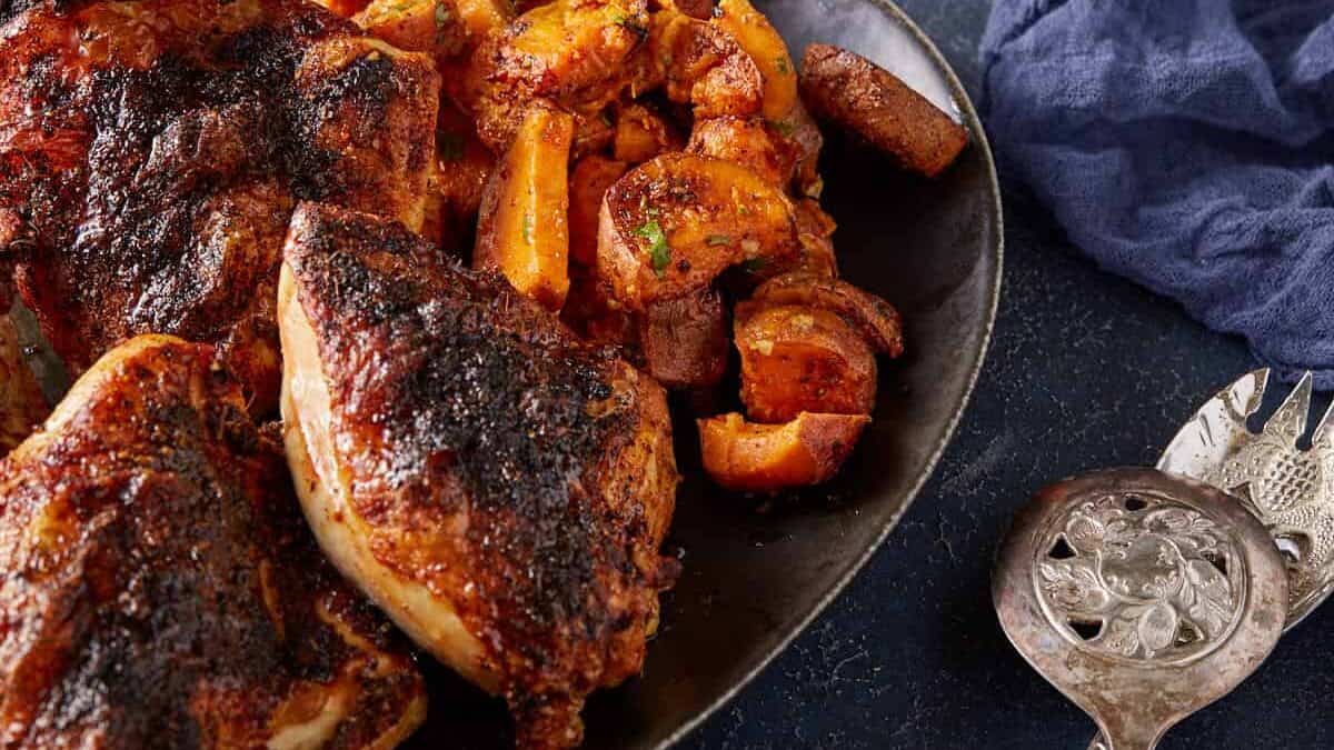 A platter of sweet potatoes and chicken.