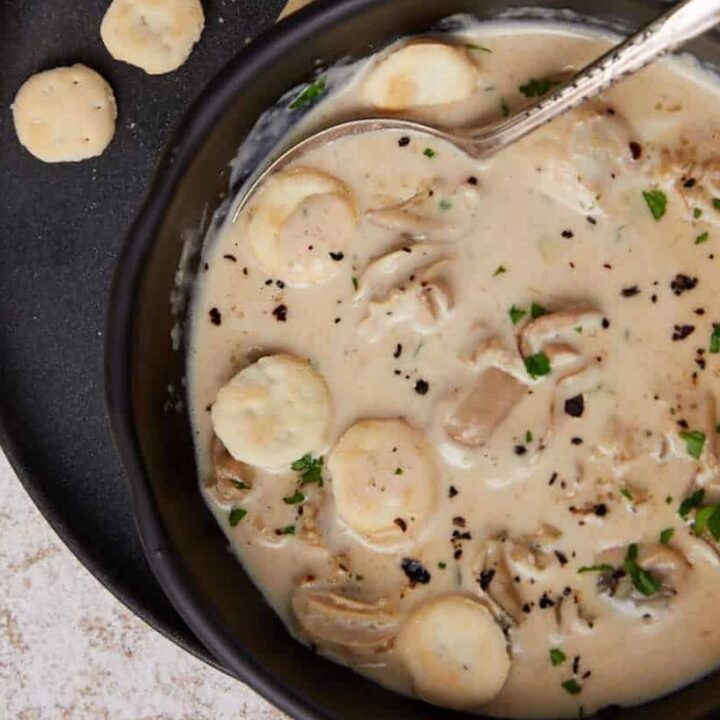 A bowl of oyster soup with oyster crackers.