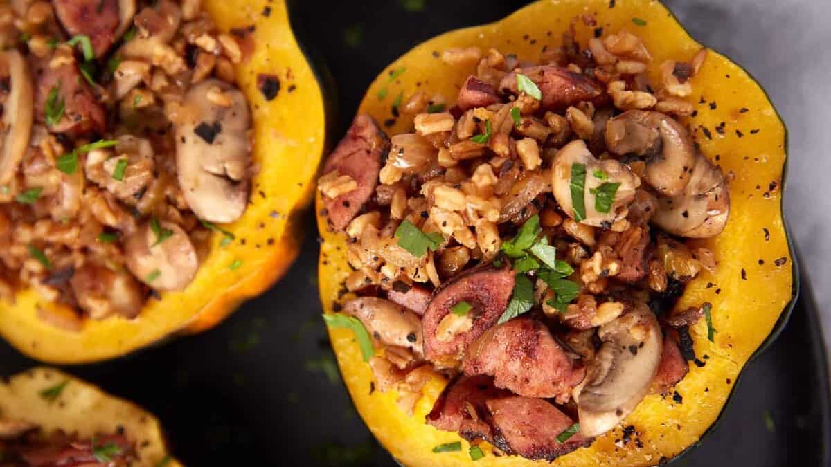 stuffed acorn squash halves on a dark background.