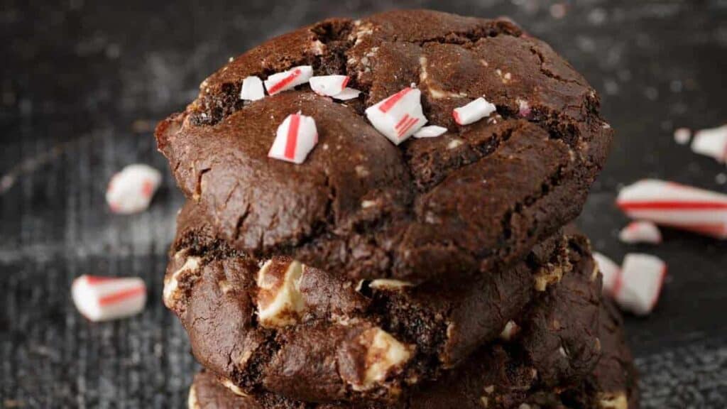 A glass of milk and chocolate Christmas cookies.