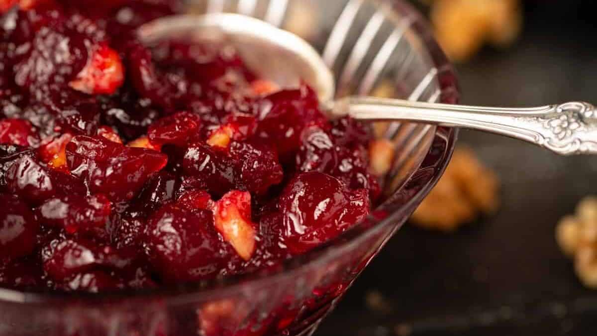 A glass dish full of homemade cranberry sauce.