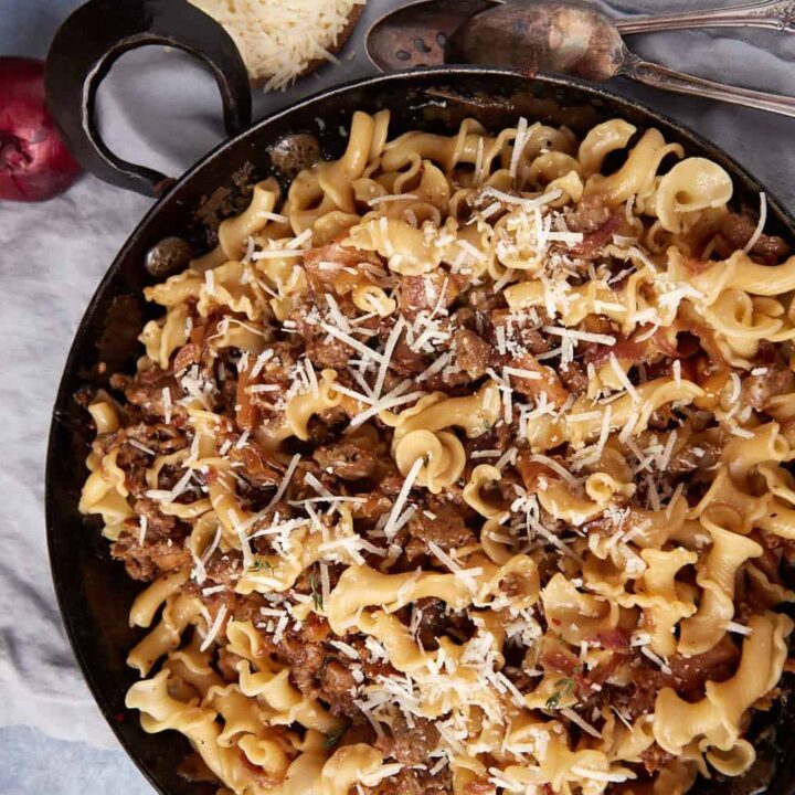 A bowl of pasta with Italian sausage.